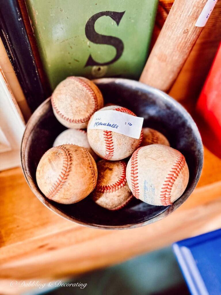 Bowl of old baseballs on shelf at Sage Farm Antiques.