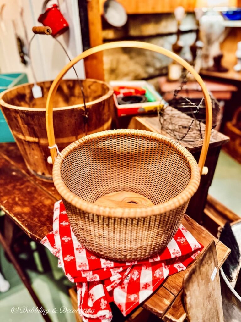 Nantucket Basket on red and white tablecloth at flea market.