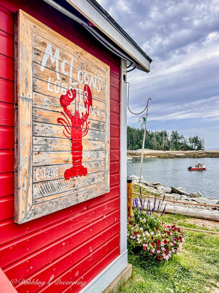 McLoon's Lobster Shack Sign on red building in Coastal Maine town.