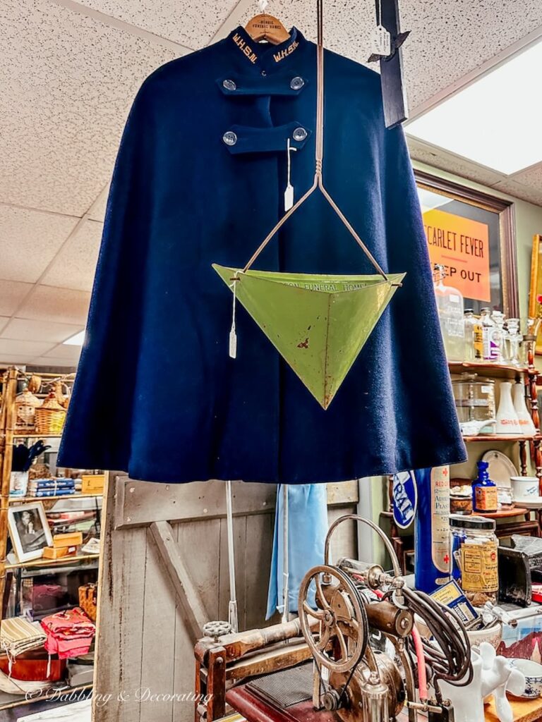 Vintage blue military nurse cape in antique shop.