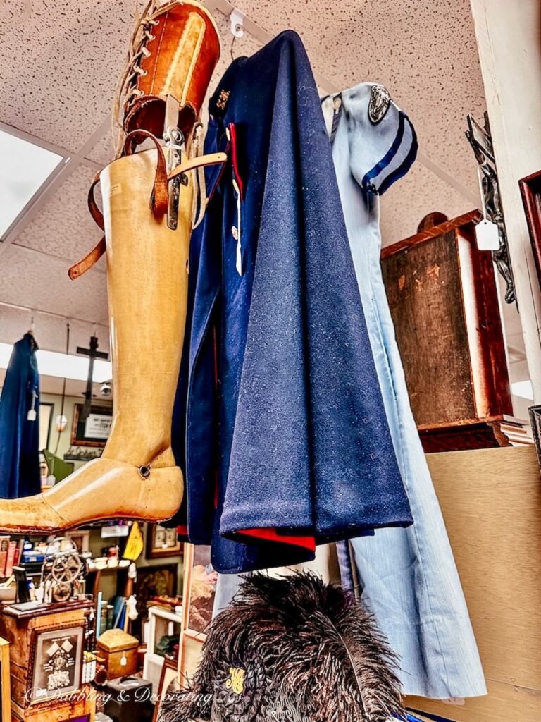 Vintage blue military nurse cape, wooden leg and nurse uniform in antique shop.