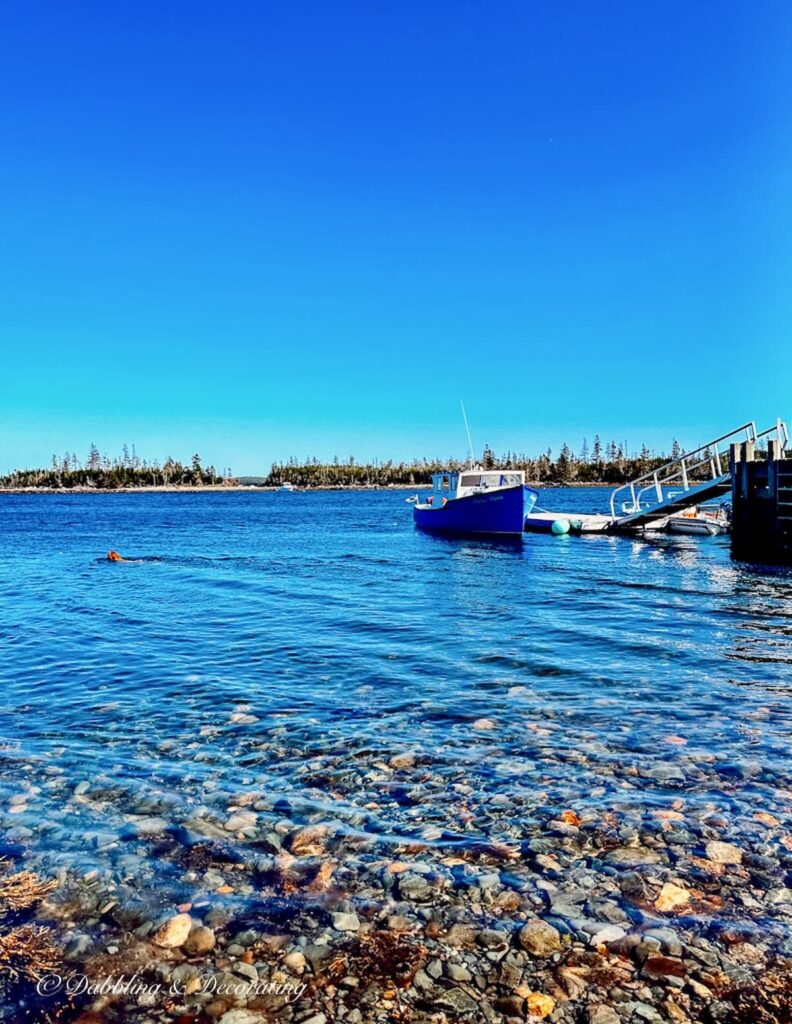 Blue fishing boat in Murphy Cove Nova Scotia.