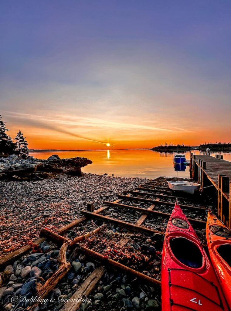 Nova Scotia Sunrise on the water with kayaks.