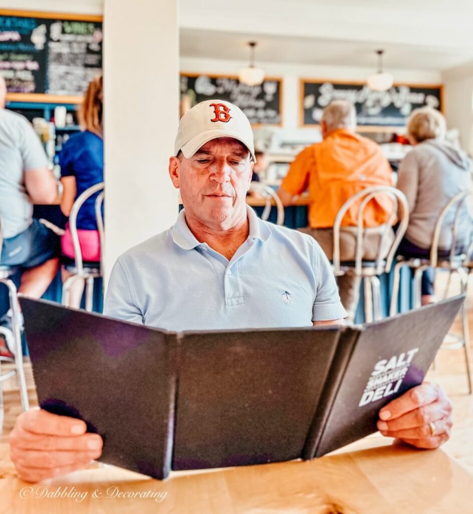 Man with menu in Lunenburg Nova Scotia restaurant.