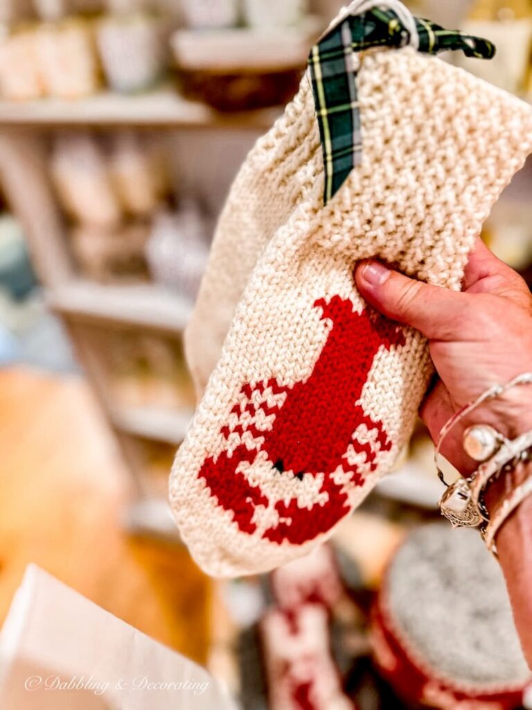 Handmade lobster mittens in hand.