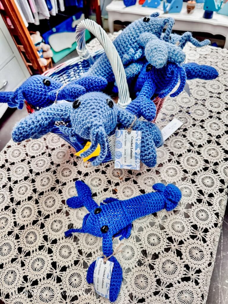 Basket filled with handmade blue lobster in store.