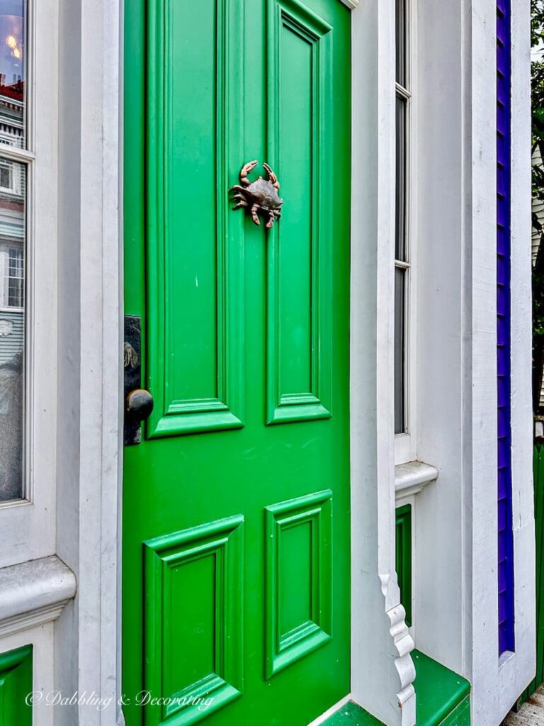 Green door with brass crab door knocker on exterior home on Nova Scotia Road Trip.