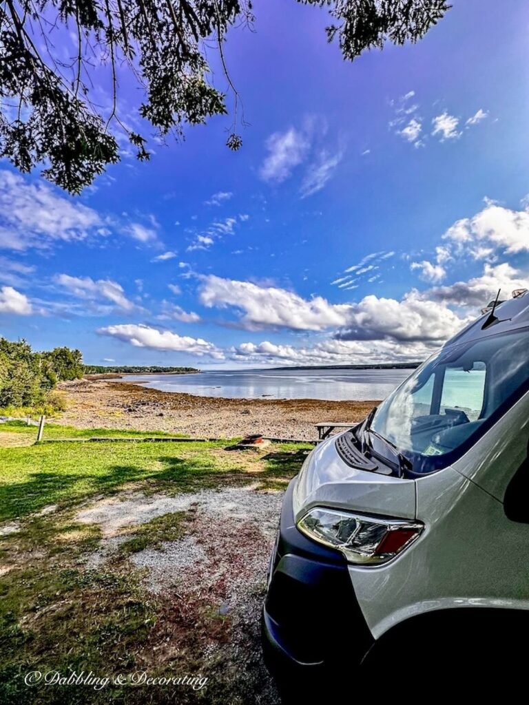 RV parked in front of the Bay of Fundy at a Camp Site.