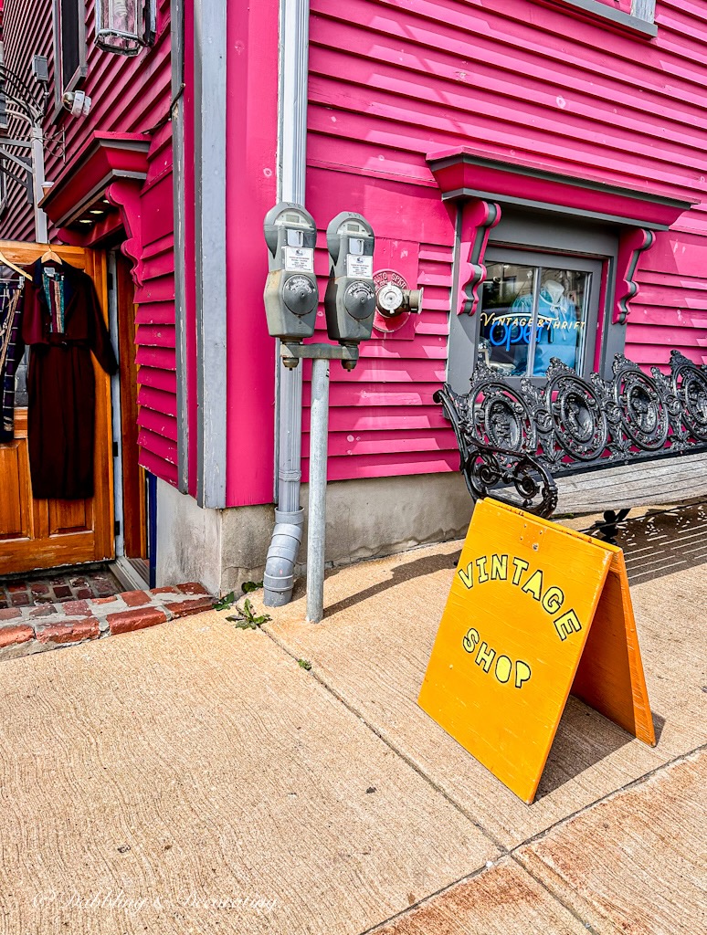 Vintage Shop Sign in front of pink building in Lunenburg Nova Scotia.