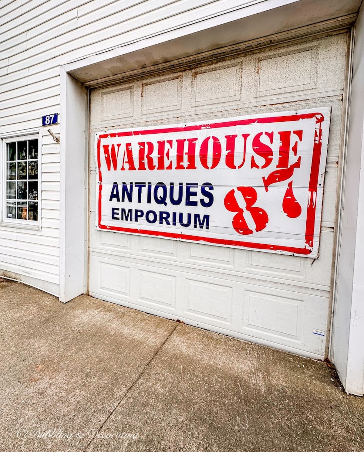 Warehouse Antiques Emporium sign on garage door in Yarmouth Nova Scotia.