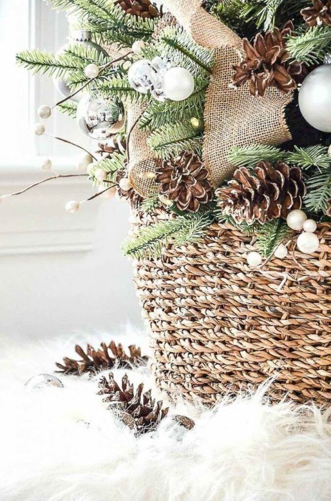 Christmas basket with evergreen, pinecones, and burlap.