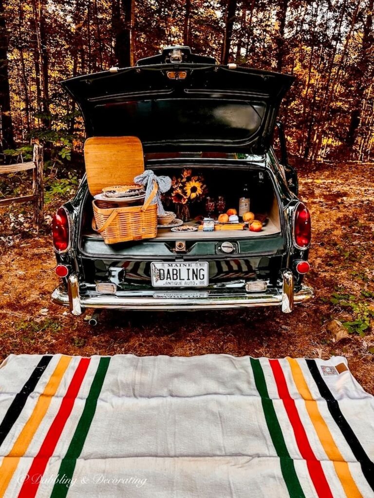 Car picnic in the woods with a Pendleton Blanket laid out on the ground.