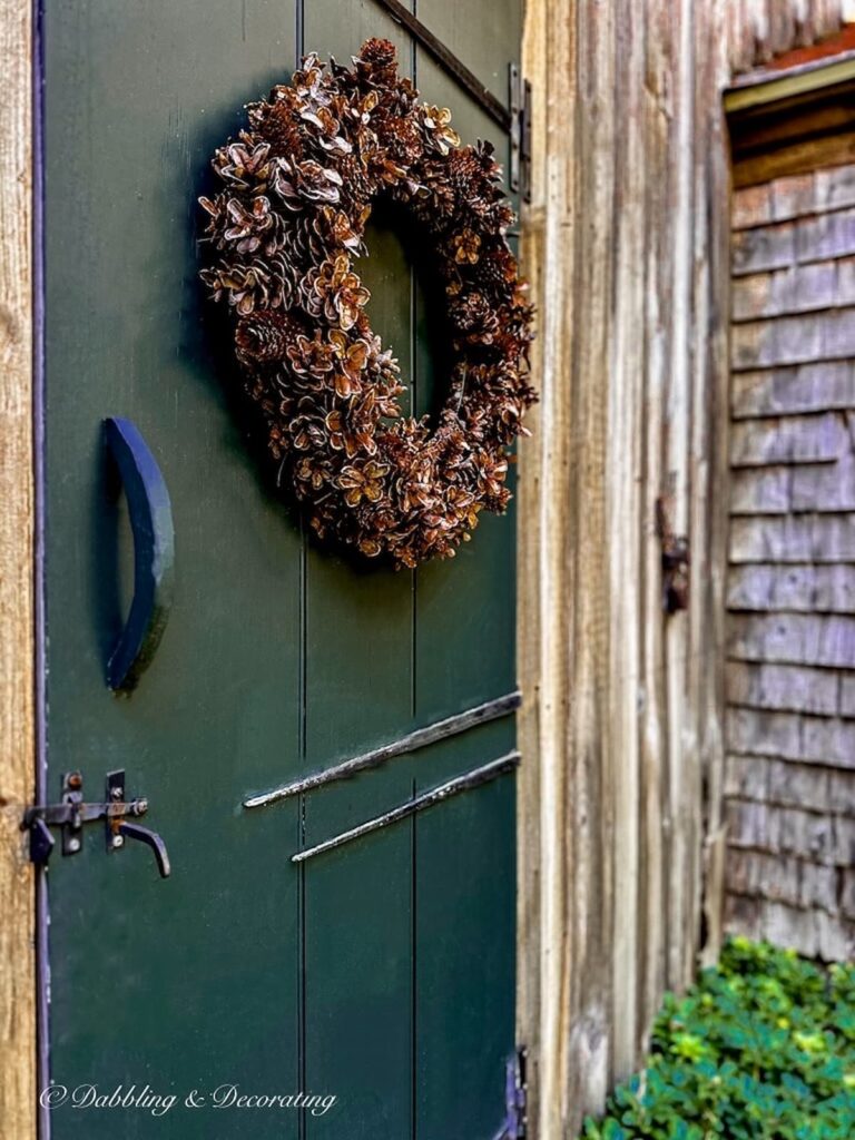 Pine Cone Wreath on Rustic Green Door.