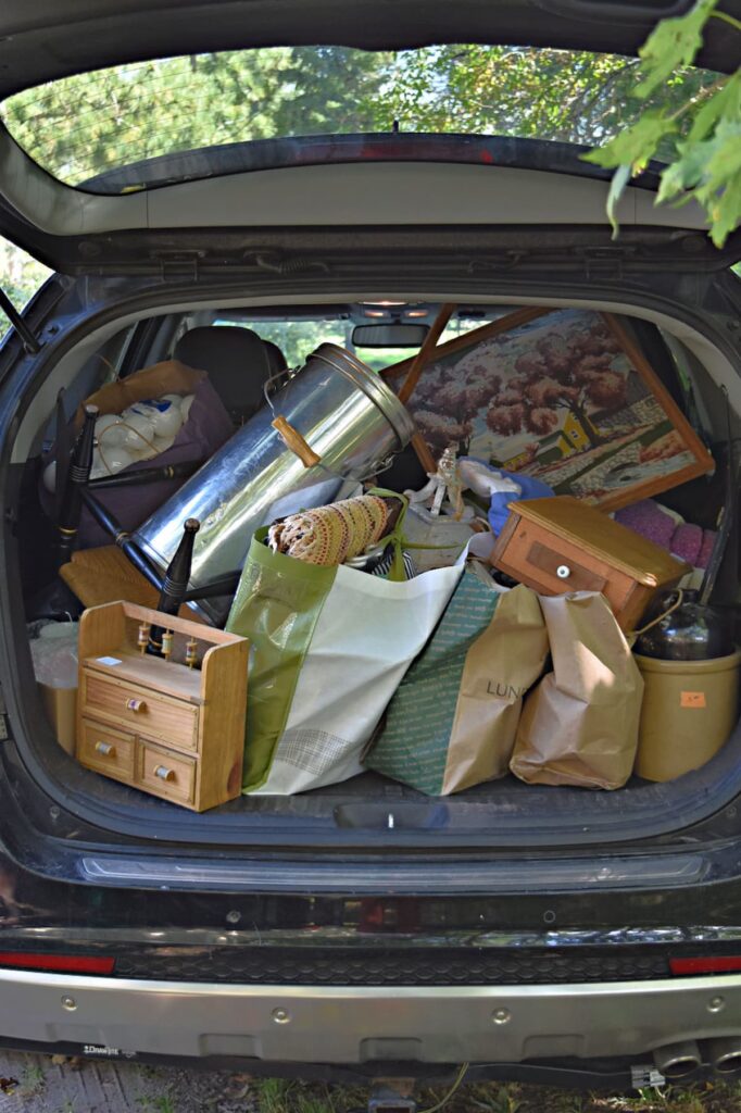 Car trunk filled with thrifted vintage finds.