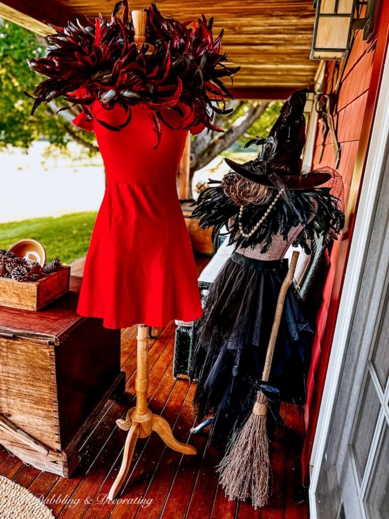 Red dress on mannequin and red feathers and witchy decor on vintage mannequin.