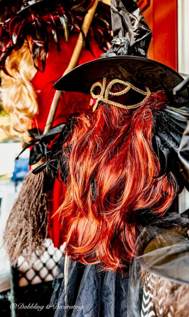 Orange wig with masquerade mask, witches hat for Halloween decor.