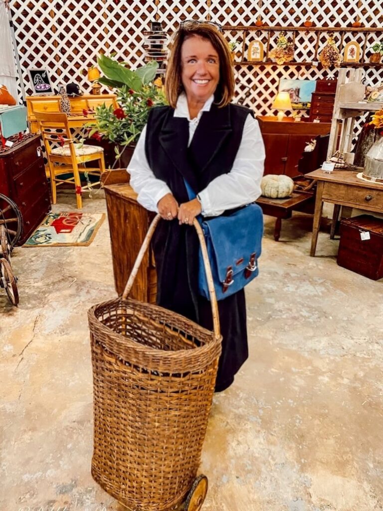 Woman holding an antique French basket at Vintage Market Days Vermont.