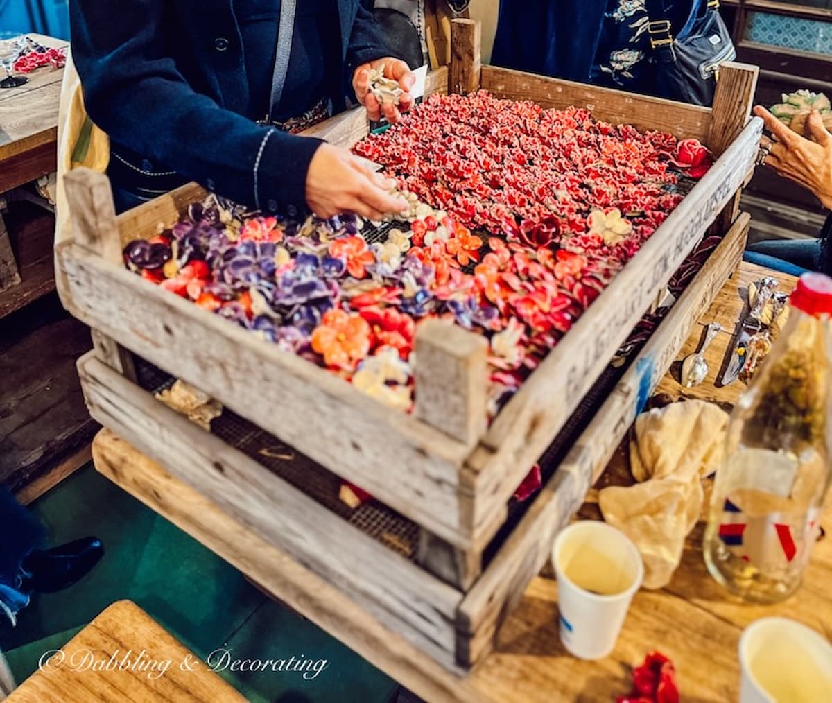 colorful ceramic flowers, immortelles in crate.