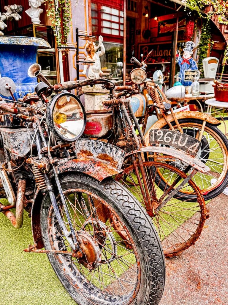 Antique French motor bikes at flea market display.