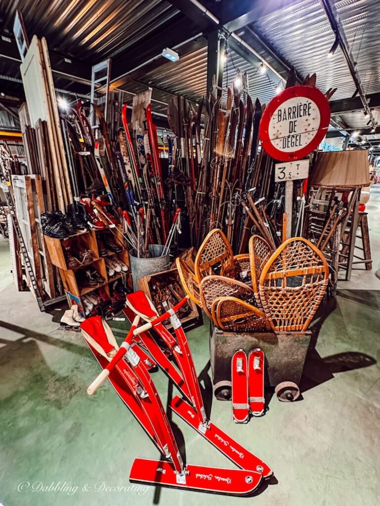 Vintage ski lodge snowshoes, sleds and skis in vintage store in France.