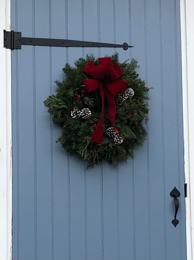 Antique blue outdoor door with Christmas wreath.