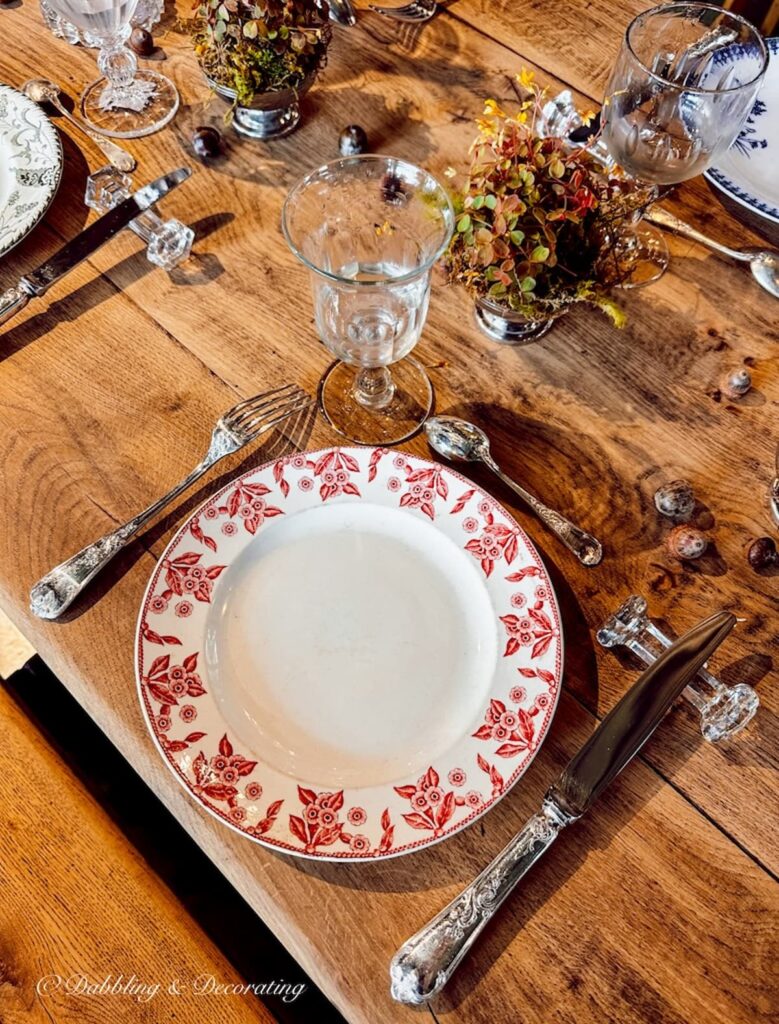 Place setting on wooden dinner table.