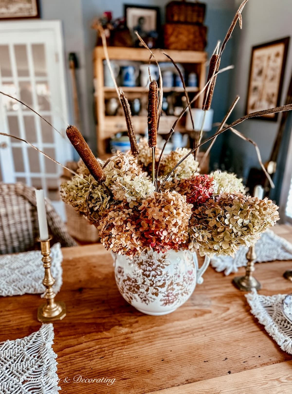 Brown Transferware large pitcher with fall hydrangeas and cattails on vintage table.