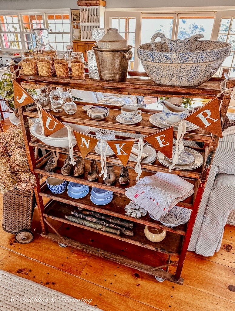 Vintage cobbler rack with vintage finds and a "Junker" garland.