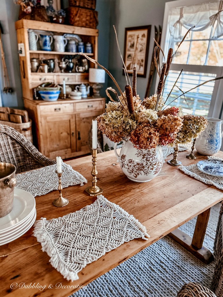 Brown Transferware large pitcher with fall hydrangeas and cattails on vintage table in dining room.