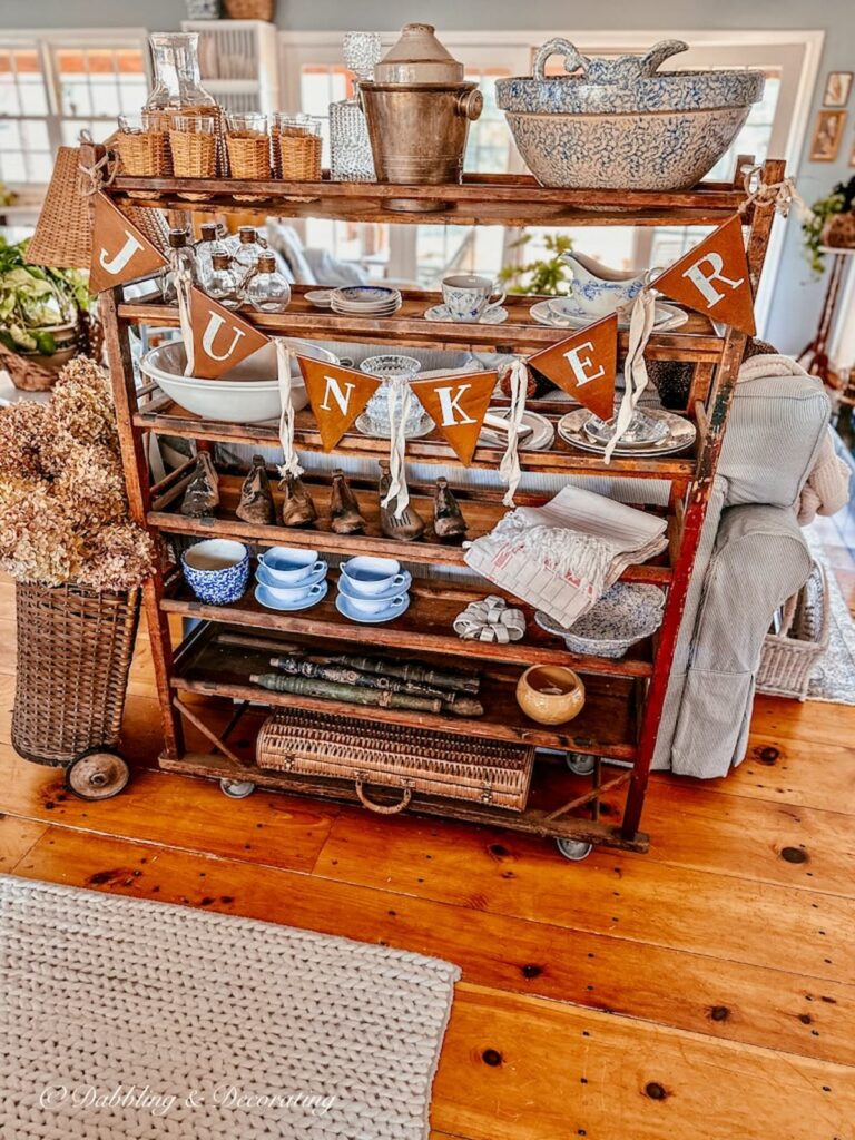 Vintage cobbler rack filled with vintage collections in open floor plan space.