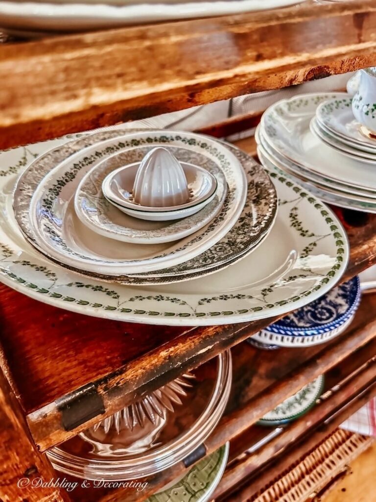 Stack of green and white vintage platters and juicer.