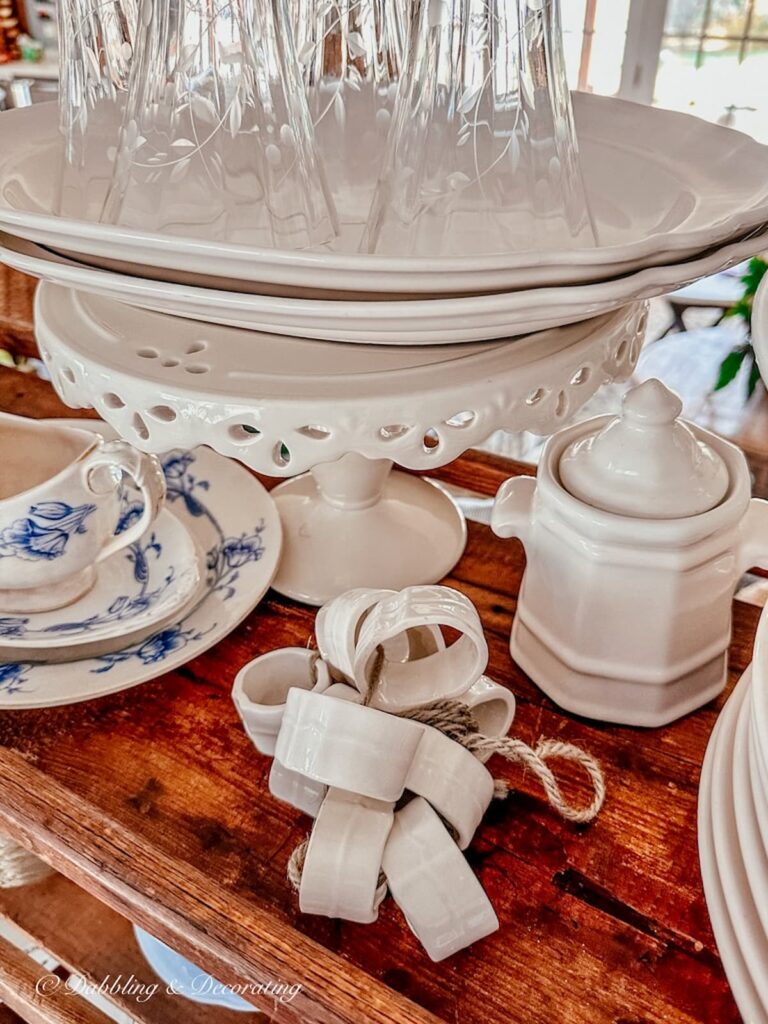 Ironstone napkin rings on vintage cobbler rack.