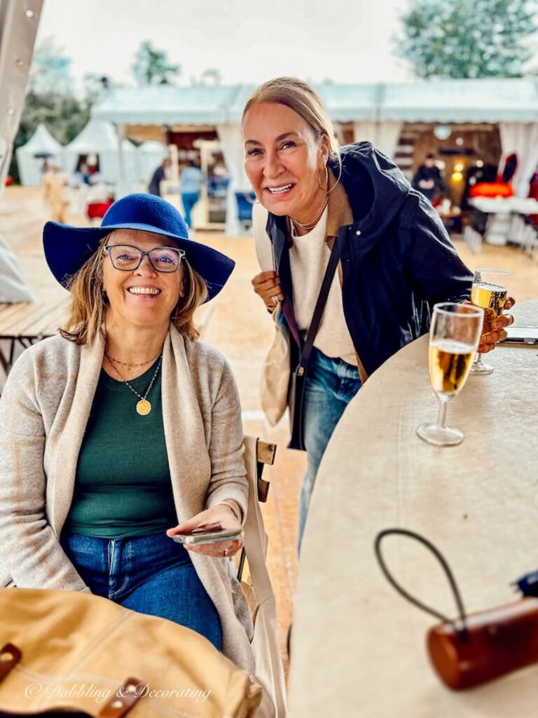 Two women at Paris antiques flea market with Champagne.