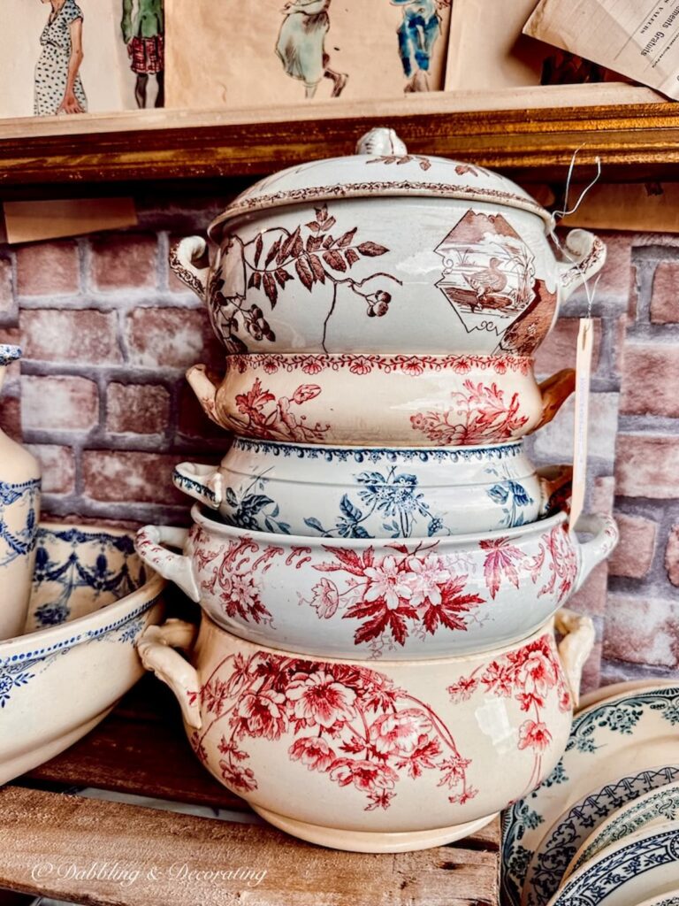 a stack of five antique soup tureens at a Paris flea market.