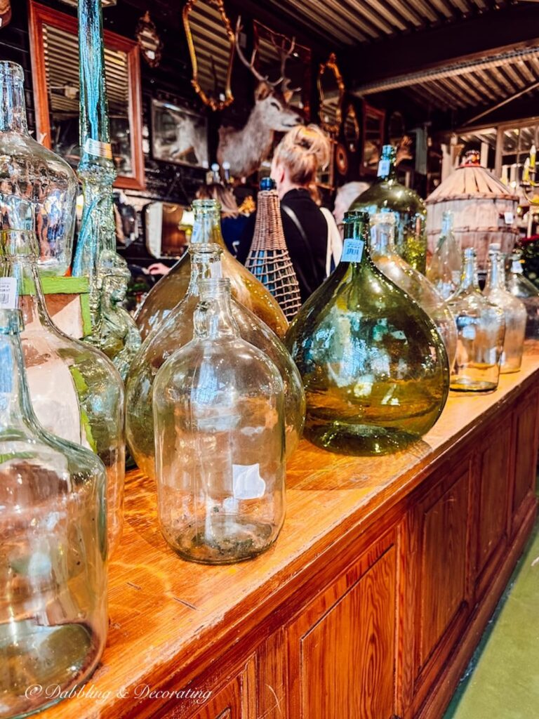 Antique green bottles in private antique warehouse in Paris.