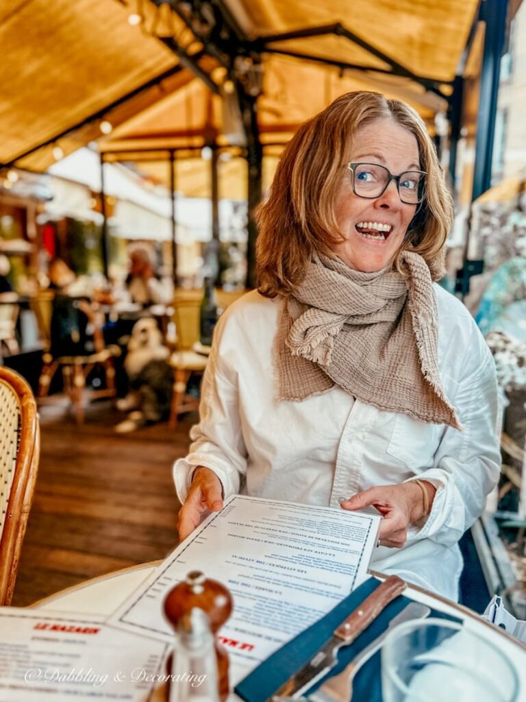 Woman laughing in Paris cafe.