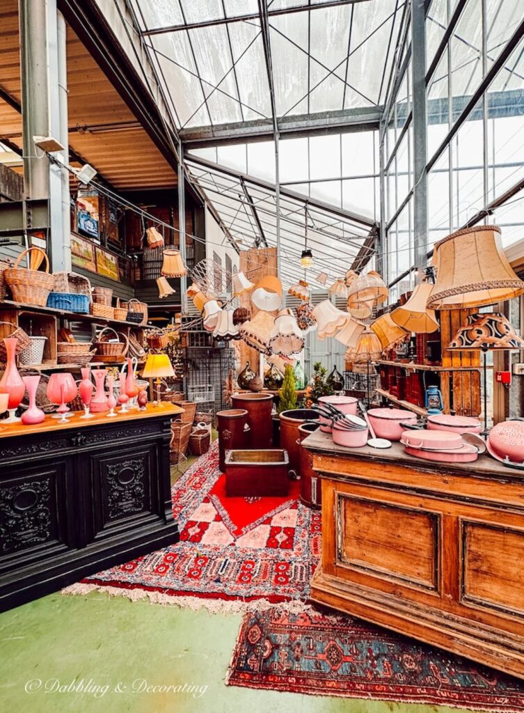 Private warehouse antique displays with lampshades and antiques in Paris.