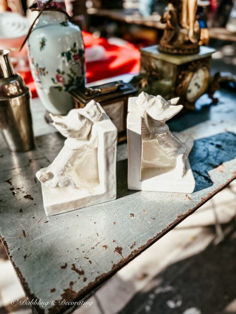 White porcelain Westie dog bookends at street fair in Paris.