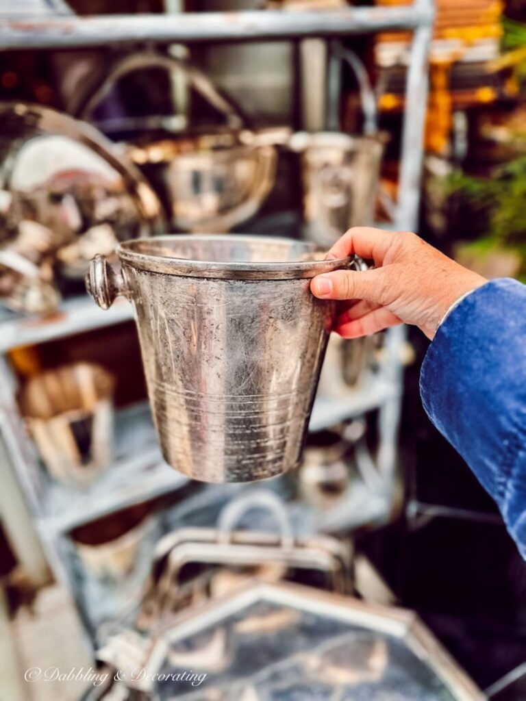 Silver antique ice bucket at an open air flea market.