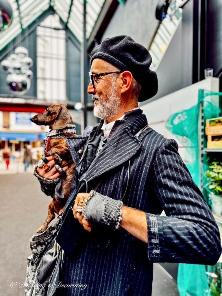 Eccentric man with Daschund at Paris Flea Market.