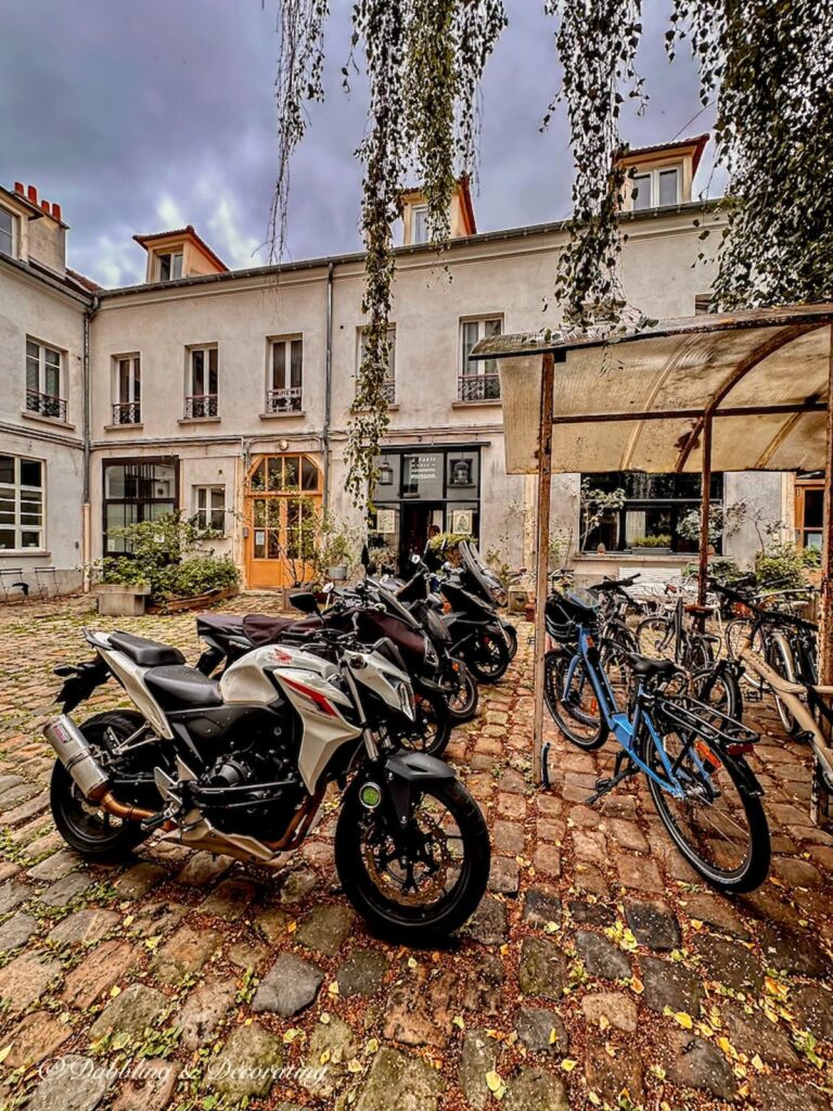 The design studio with motorcycles out front of ANTOINETTE POISSON courtyard.