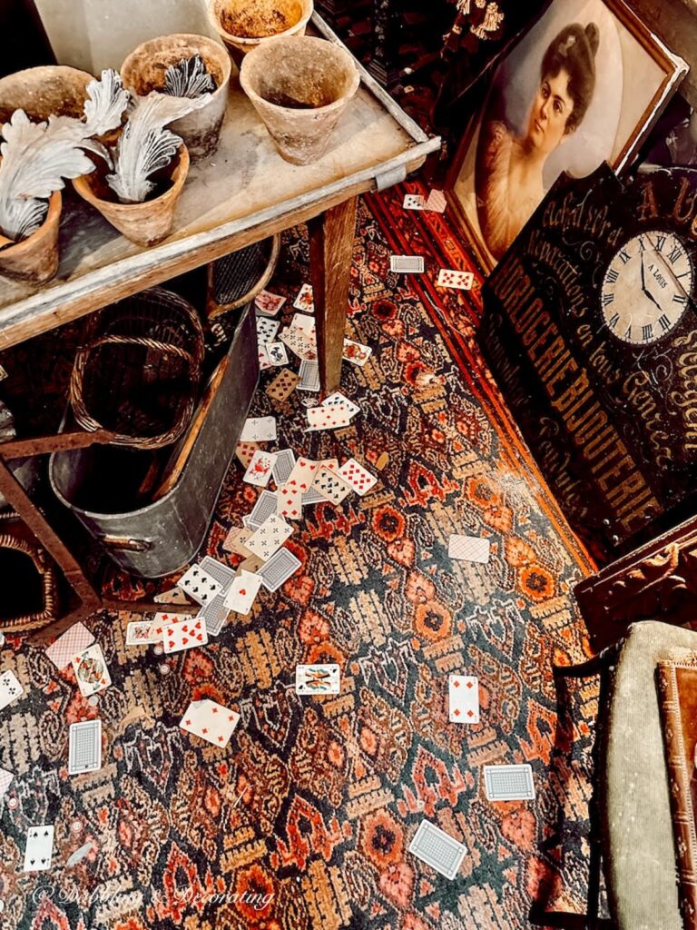 Deck of cards scattered all over antique dealers booth at flea market in Paris.