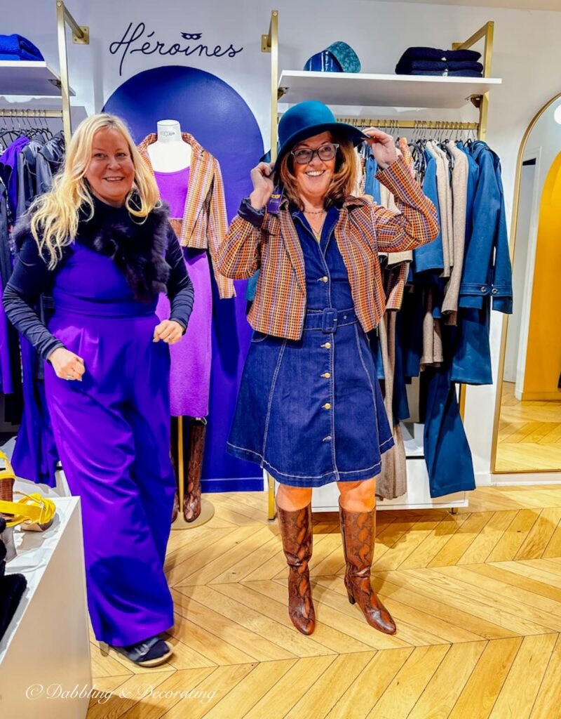 Two woman in Paris boutique trying on clothing.