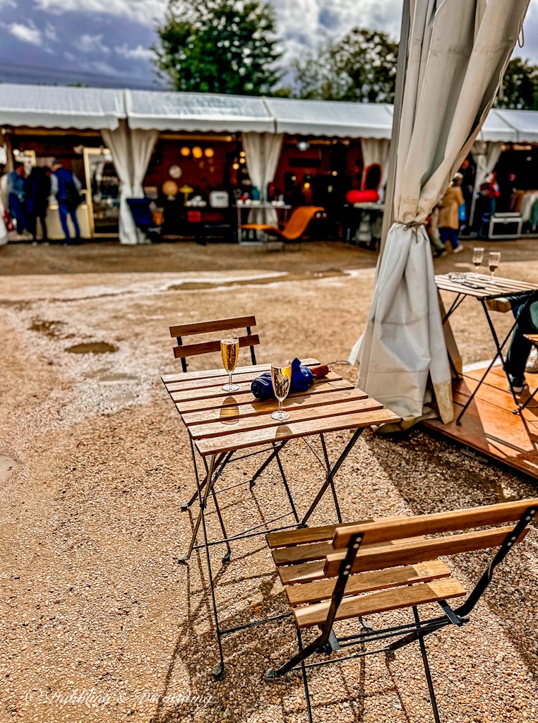 Table and two chairs at Paris antiques flea market with champagne.