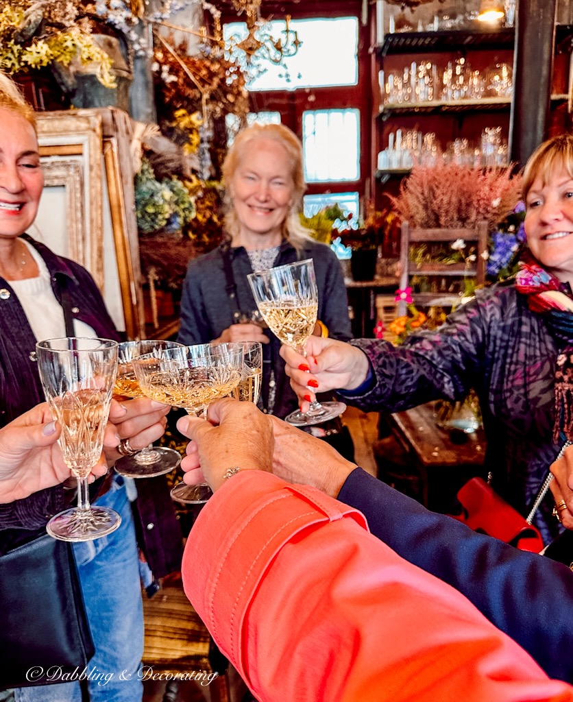 Women toasting champagne at a flower workshop in Paris France