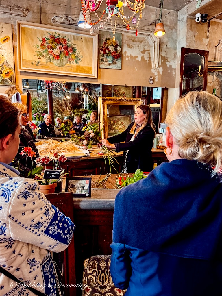 Woman teaching a French flower bouquet workshop in a flower shop.