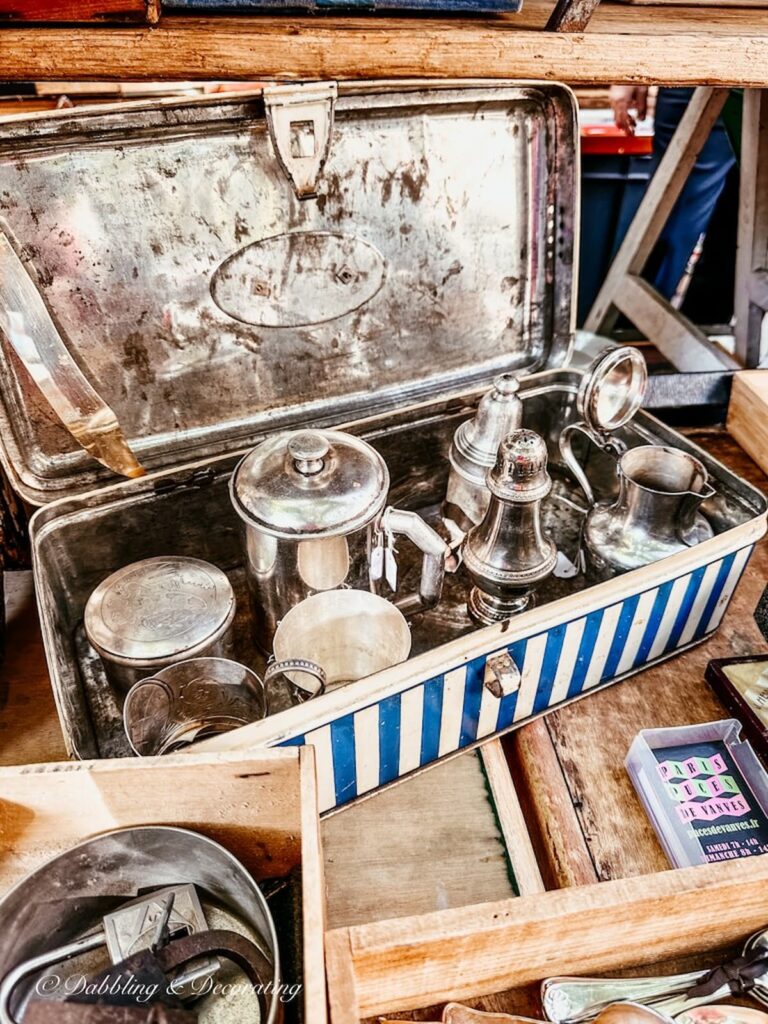 Antique blue and white tin filled with silver at Paris street fair.