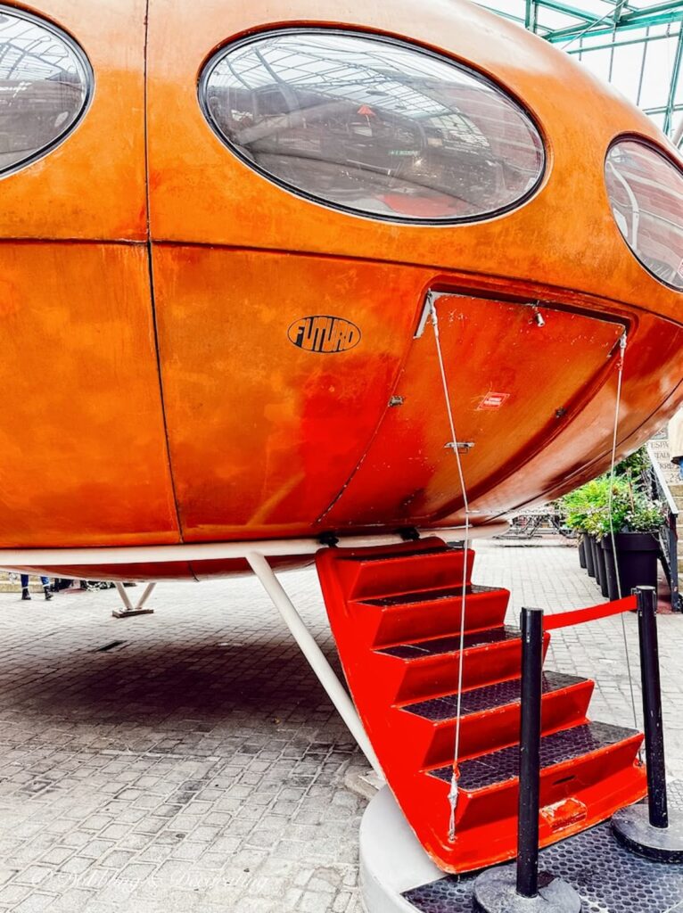 Orange retro space ship lounge at flea market in Paris.