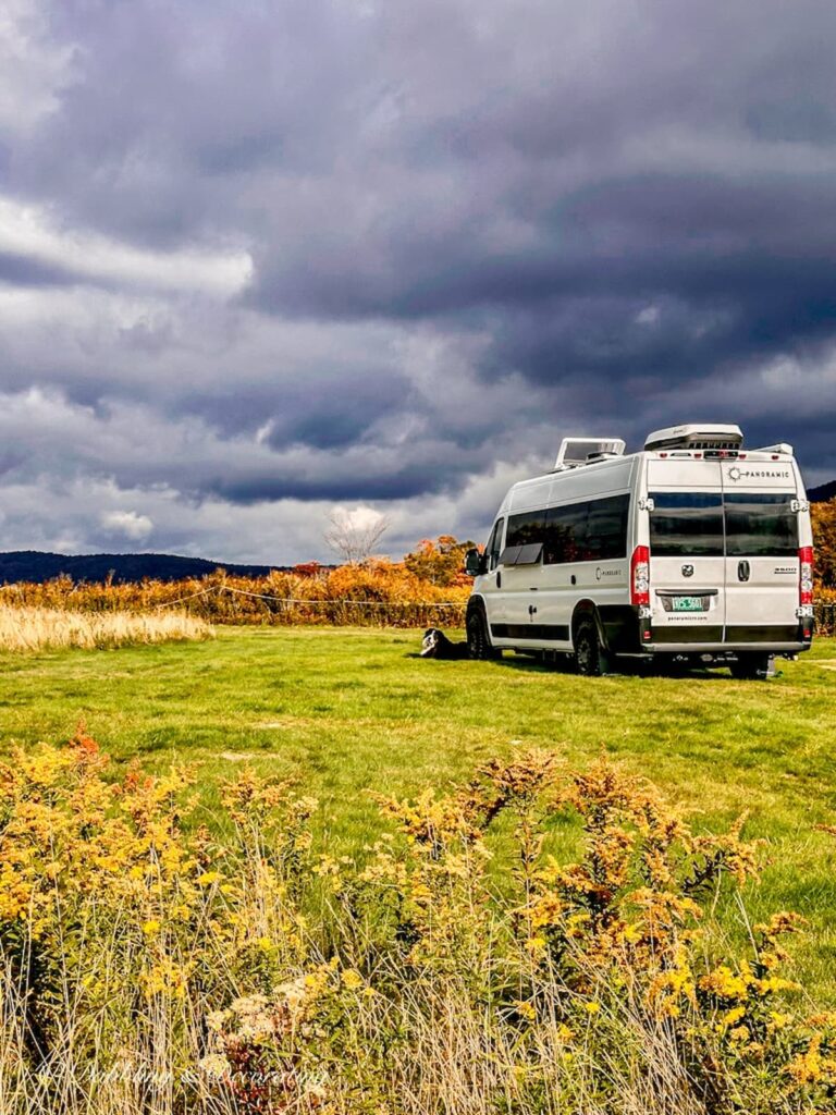 Panoramic RV class B white camping in Vermont fall foliage.