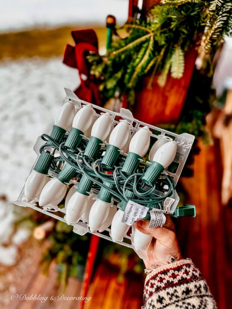 Vintage Christmas white lights in hand.